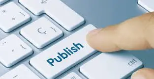 Finger pressing a blue Publish key on a computer keyboard